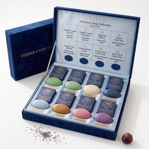 Vesper Discovery Soap Collection gift set shown open, with 8 individually wrapped round soaps in blue velvet compartments and a matching blue presentation box behind it on a white background.